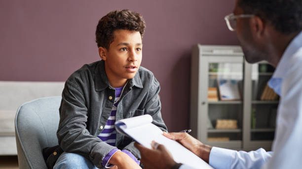 Excited teenage boy sharing his thoughts with adolescent psychologist